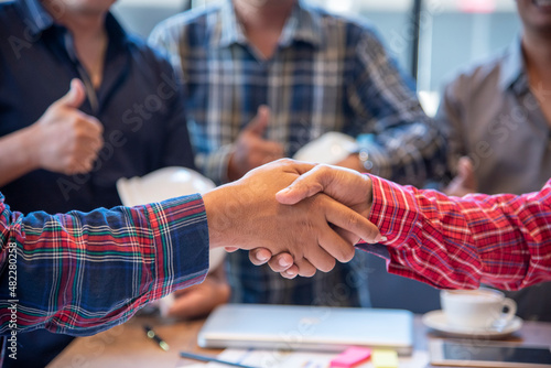 Team Business Partners shaking hands together to Greeting Start up small business in meeting room. Shakehand teamwork partners at modern office handshake together. Business mergers and acquisitions © aFotostock