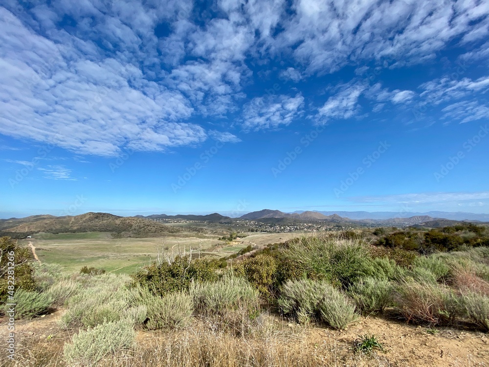Wide view across scrubland towards mountains in Thousand Oaks area, CA, seen from Point Mugu State Park. Typical Southern California suburban homes in the distance Wide view across scrubland towards mountains in Thousand Oaks area, CA, seen from Point Mugu State Park. Typical Southern California suburban homes in the distance