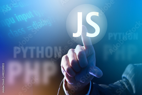 JS letters in front of human hand. Concept of choosing Javascript language to study. Learning programming with javascript. Learning javascript and other development languages. Software development photo