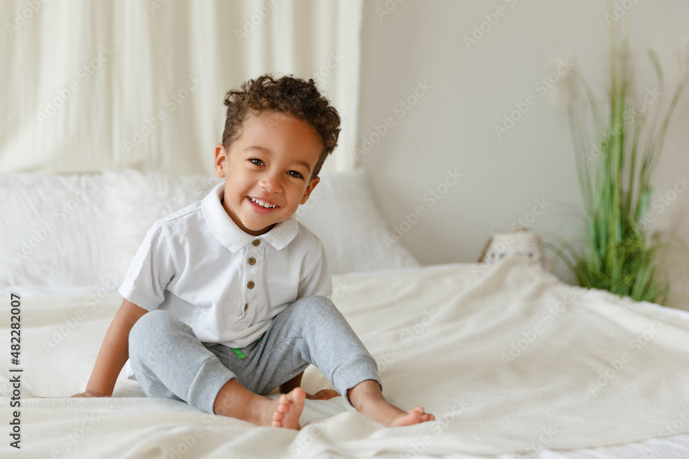 Little smiling boy. playing afro american toddler. Positive kid. Cute baby. The concept of a happy childhood and child care. Little smiling boy. playing afro american toddler. Positive kid. Cute baby. The concept of a happy childhood and child care.