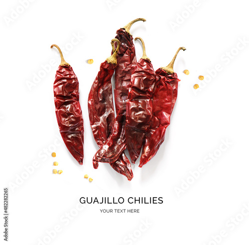 Creative layout made of guajillo chilies on the white background. Flat lay. Food concept. photo