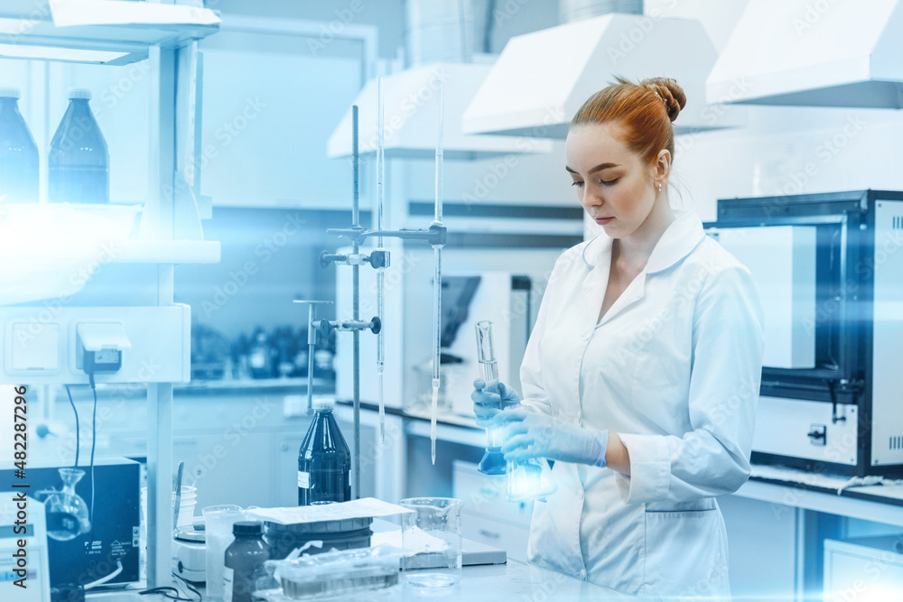 Professional female scientist is working on a vaccine in a scientific research laboratory. Genetic engineer workplace. Technology and science concept. Stop COVID-19 Professional female scientist is working on a vaccine in a scientific research laboratory. Genetic engineer workplace. Technology and science concept. Stop COVID-19