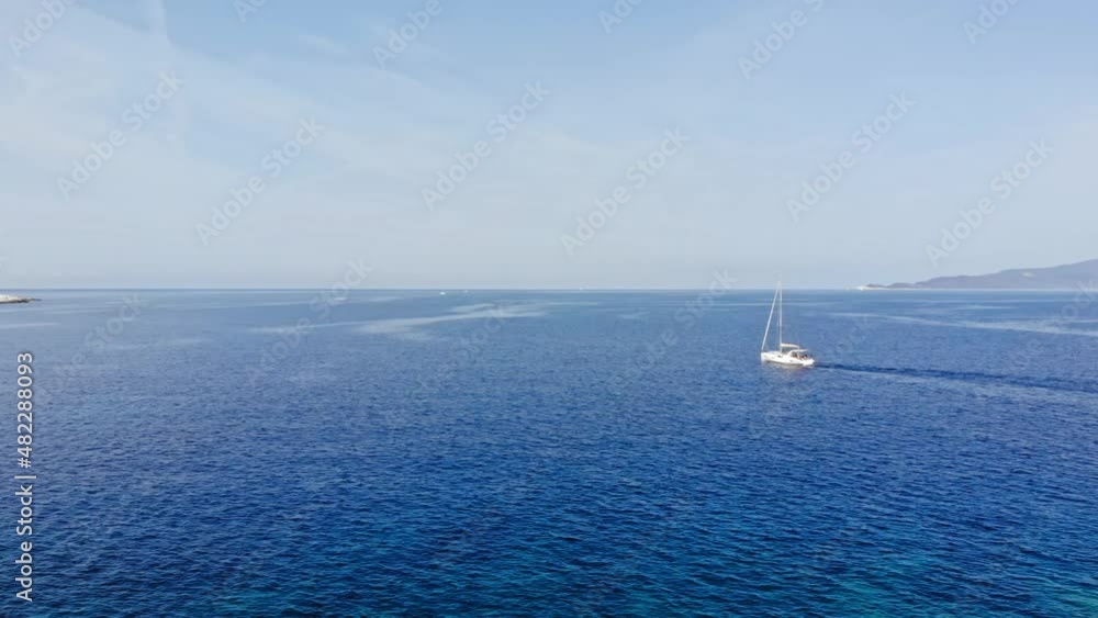 Aerial View Of Boat Sailing In The Blue Sea Towards The Emplisi Beach In Greece. - panning Aerial View Of Boat Sailing In The Blue Sea Towards The Emplisi Beach In Greece. - panning