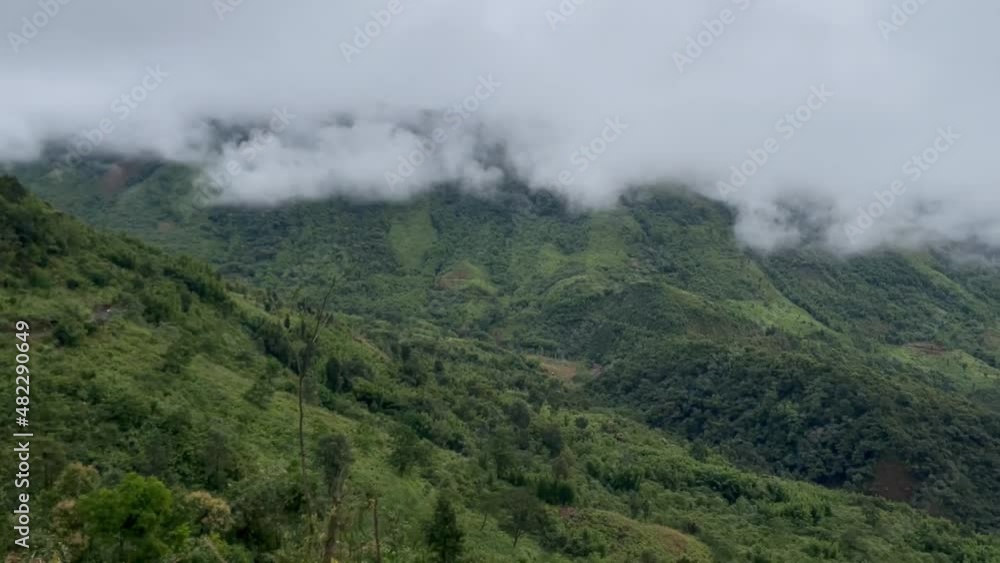 Clouds And Fogs Over Lush Green Forest And Mountain Hills In India. - wide shot Clouds And Fogs Over Lush Green Forest And Mountain Hills In India. - wide shot