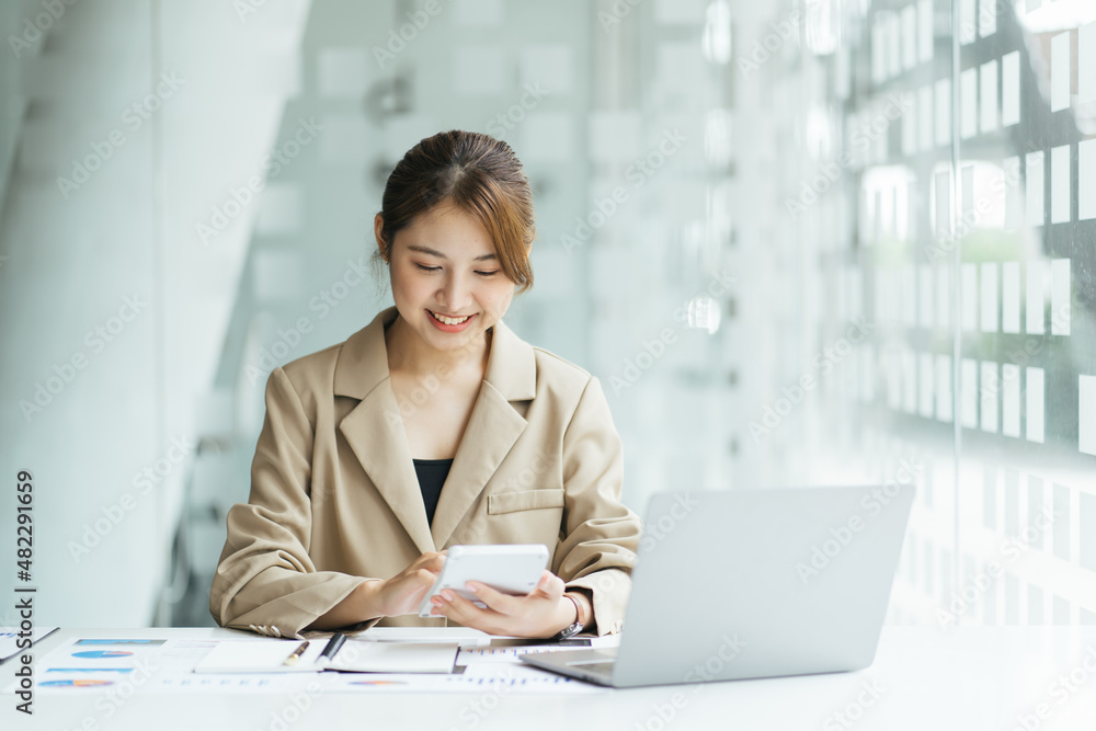 Smiling Young Asian Business women working with calculator, business document and laptop computer notebook,financial inspector and secretary making report,Internal Revenue Service checking document. Smiling Young Asian Business women working with calculator, business document and laptop computer notebook,financial inspector and secretary making report,Internal Revenue Service checking document.