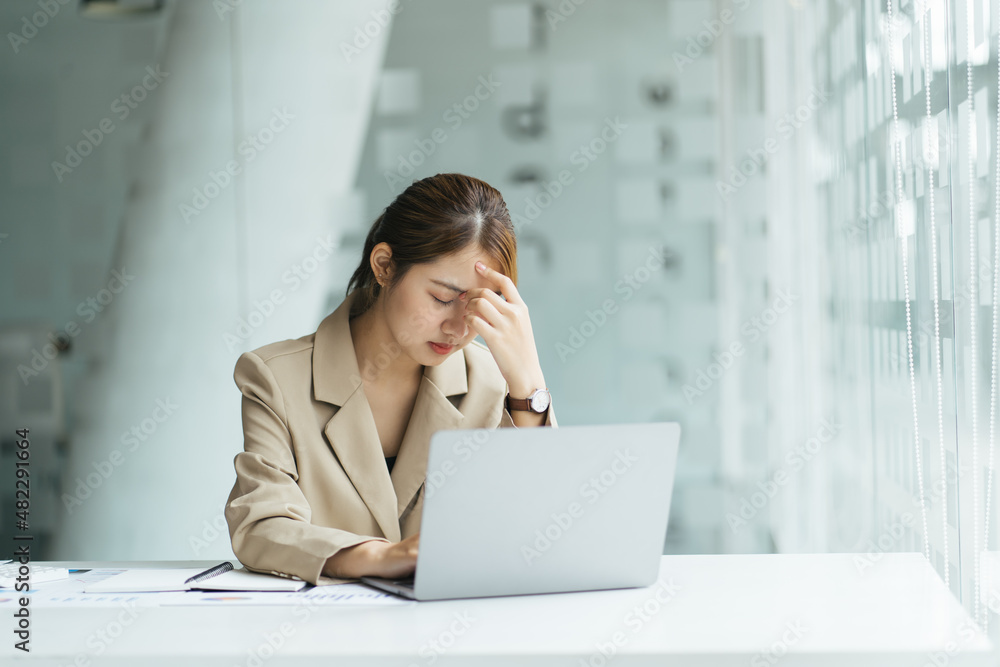 Young and beautiful businesswoman tired from work in the office Young and beautiful businesswoman tired from work in the office