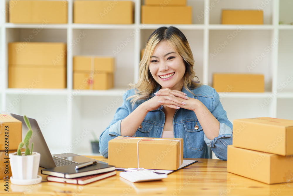 Asian young woman start up small business owner packing in the box at workplace. Online selling, woman seller prepare product for packaging process at home, internet marketing, e-commerce concept. Asian young woman start up small business owner packing in the box at workplace. Online selling, woman seller prepare product for packaging process at home, internet marketing, e-commerce concept.