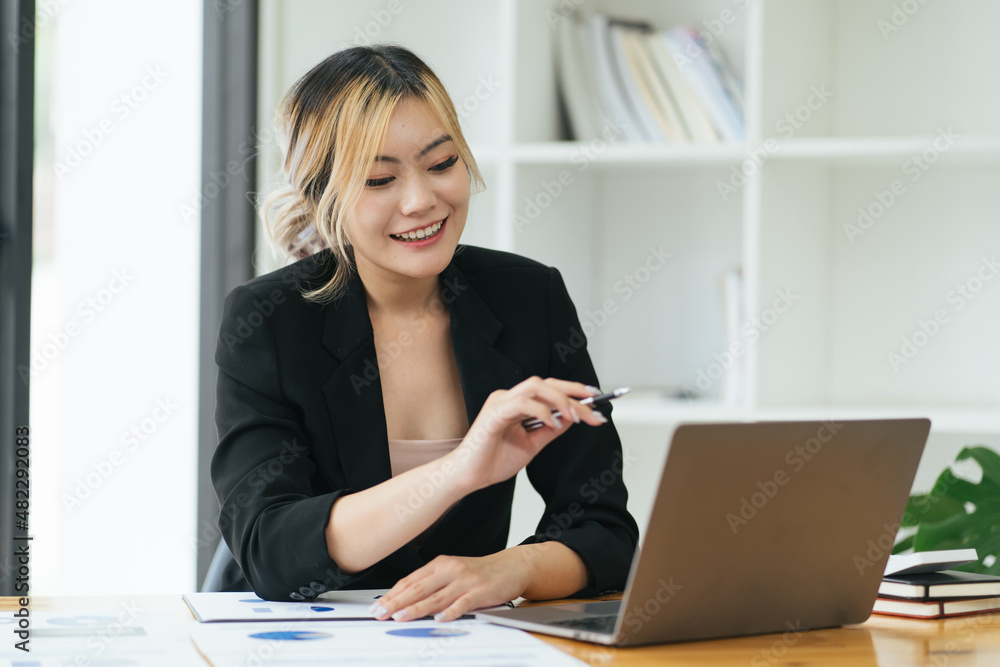 business woman talking about sale report in video conference. Asian team using laptop and tablet online meeting in video call.Working from home, Working remotely and Social isolation. business woman talking about sale report in video conference. Asian team using laptop and tablet online meeting in video call.Working from home, Working remotely and Social isolation.