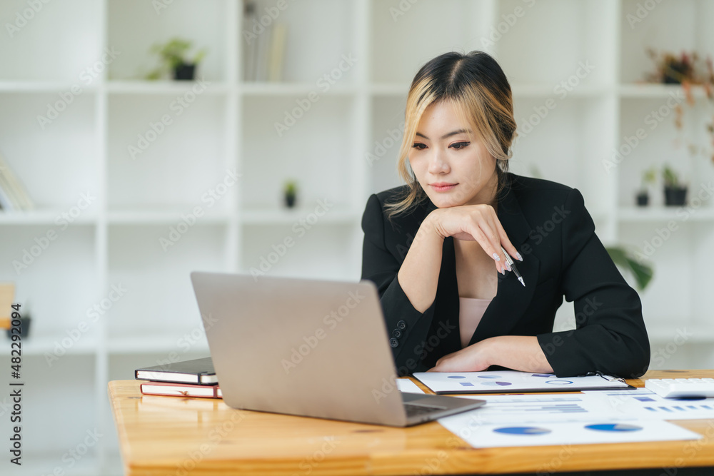 Portrait Of Attractive Asian Businesswoman Working On Laptop for marketing plan. Portrait Of Attractive Asian Businesswoman Working On Laptop for marketing plan.