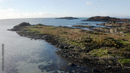 AERIAL - Rocky beaches and shallow water on the Isle of Gigha, Kintyre, Scotland photo