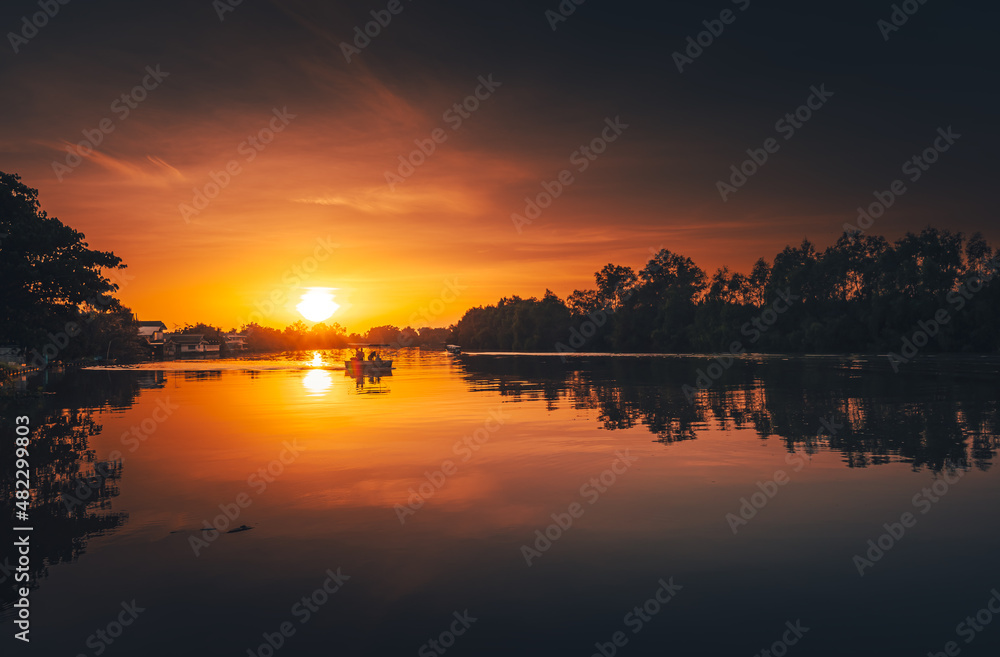 sunset at coast of the river. Nature landscape and reflection sunset.