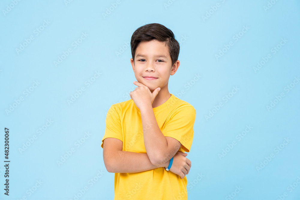 Smart mixed race boy rubbing chin