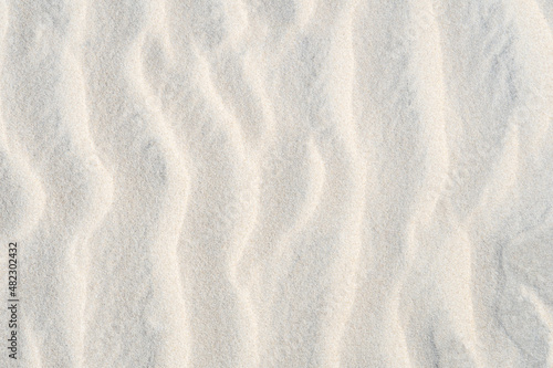 Fotografija wavy curved random nature pattern of wind blown sand surface with sunlight and s