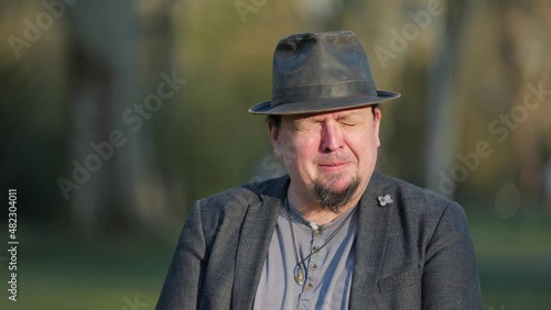 [4k] grown up man crying in park blues brother style