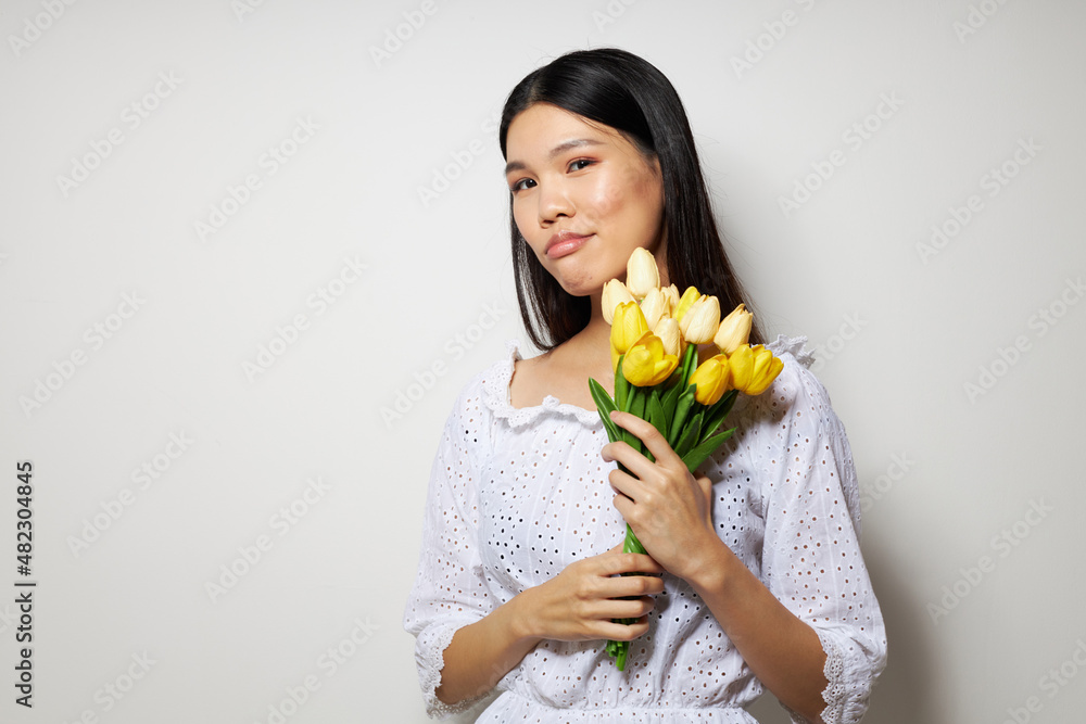 pretty brunette in a white shirt flowers spring posing isolated background unaltered pretty brunette in a white shirt flowers spring posing isolated background unaltered