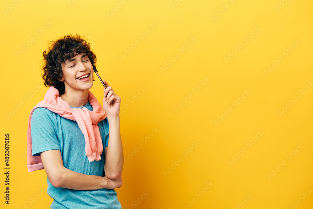 curly guy in a blue T-shirt idea pink jacket yellow background curly guy in a blue T-shirt idea pink jacket yellow background
