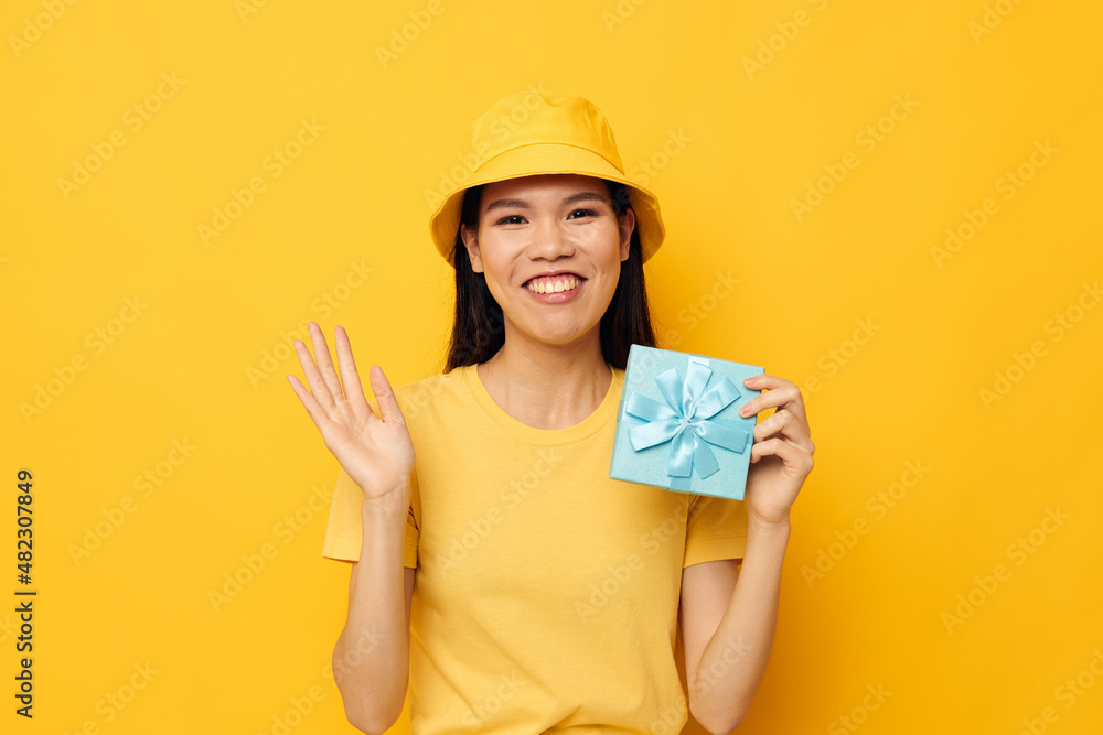 woman with Asian appearance with a gift box in his hands surprise emotions isolated background unaltered woman with Asian appearance with a gift box in his hands surprise emotions isolated background unaltered