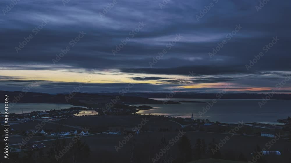 Al late winter morning over one of norwegian fjords with stunning sunrise and slowly moving clouds. Al late winter morning over one of norwegian fjords with stunning sunrise and slowly moving clouds.