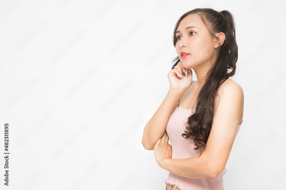 Beautiful Asian woman wearing pink casual shirt on white background and copy space. Asian woman thinking something for advertising concept Beautiful Asian woman wearing pink casual shirt on white background and copy space. Asian woman thinking something for advertising concept