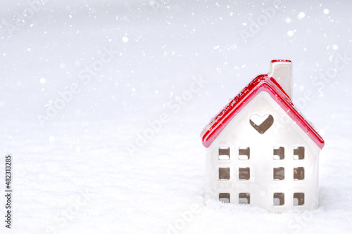 The symbol of a house in the snow with a heart is a love nest, housing for a young family, comfort with a loved one. Valentine's day, cozy, cottage, moving, mortgage, warm home