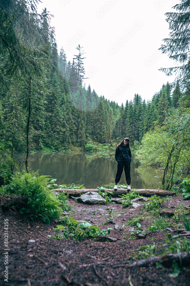 woman enjoying view of wild lake in mountains