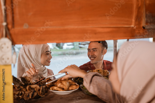 couple having dinner together at the small street food stall