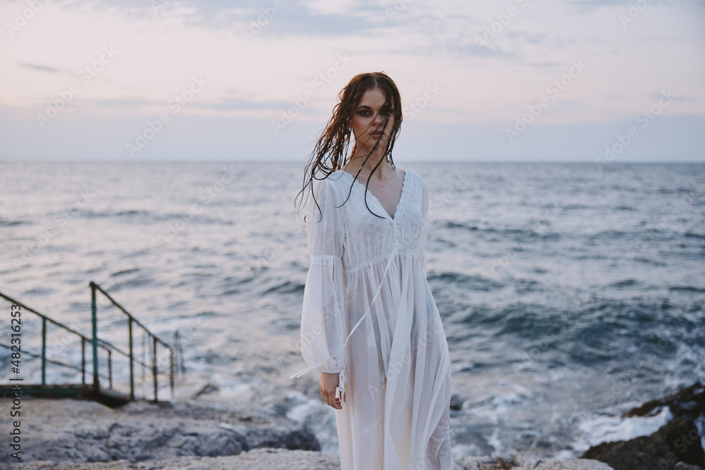 woman traveler enjoying for view of the beautiful sea on her holiday Lifestyle unaltered woman traveler enjoying for view of the beautiful sea on her holiday Lifestyle unaltered