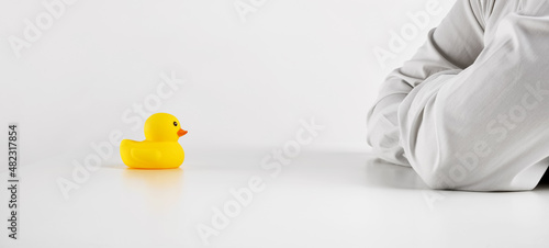 Job interview, negotiation, consulting or interrogation. Businessman interviews the rubber duckling.