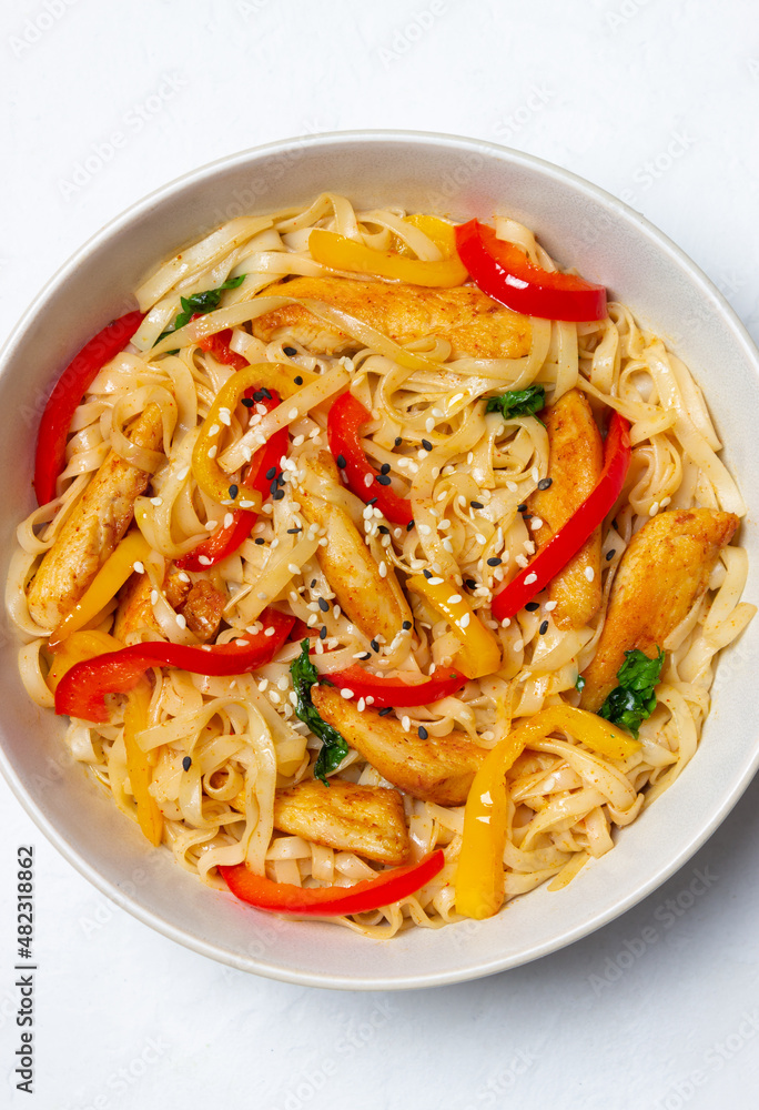 Udon noodles with chicken, pepper and sesame. Chinese food.