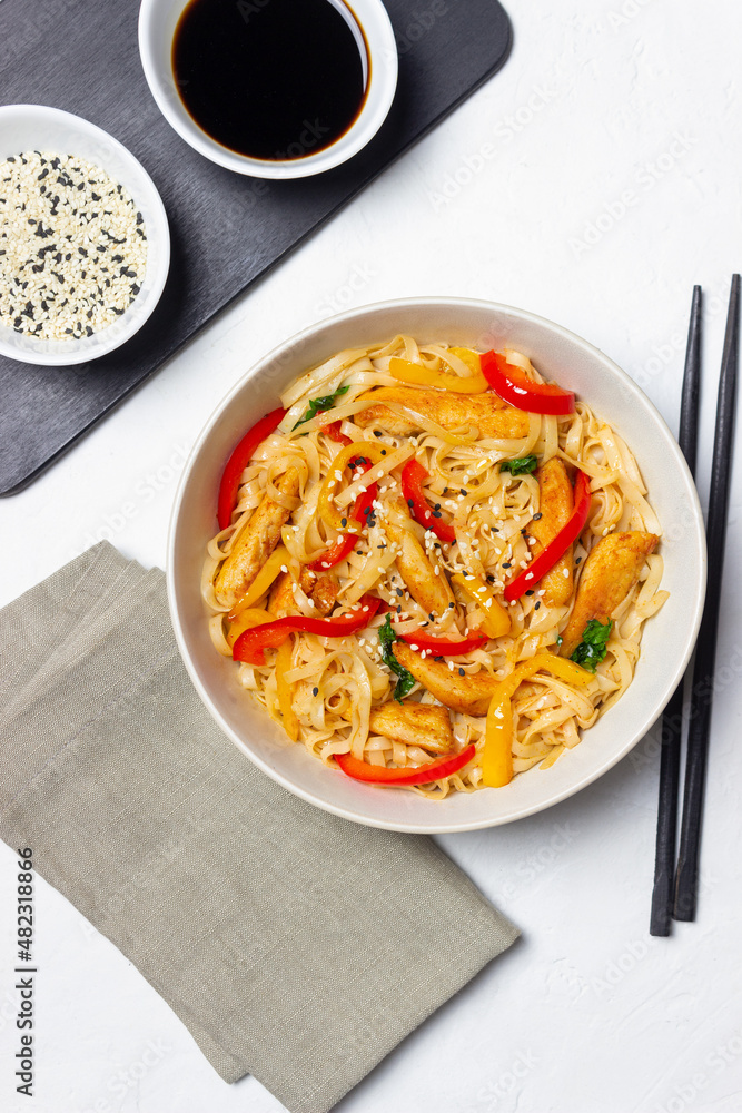 Udon noodles with chicken, pepper and sesame. Chinese food. Udon noodles with chicken, pepper and sesame. Chinese food.