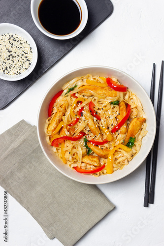 Udon noodles with chicken, pepper and sesame. Chinese food.