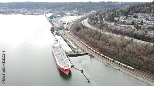 Port inlet bulk transfer station. Tanker, Rail Cars and tanker boat. photo