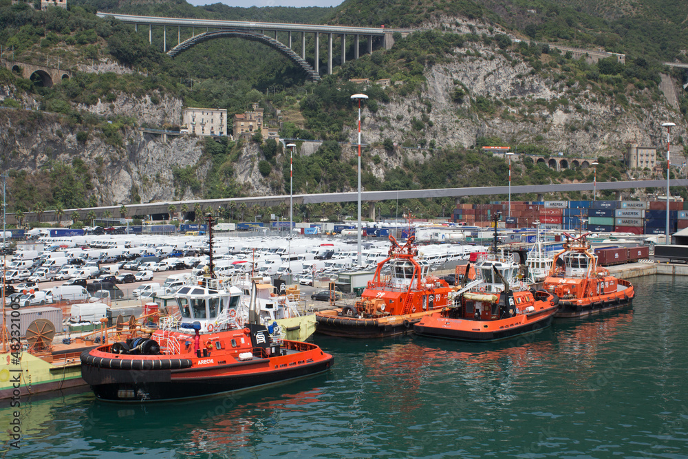 evocative image of pilot boats moored in port by a scheduled ferry
