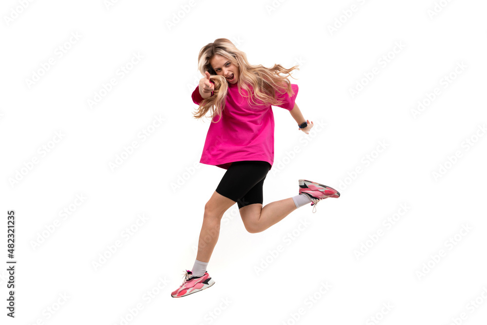 young cheerful woman in a jump on a white isolated background shows a forward gesture
