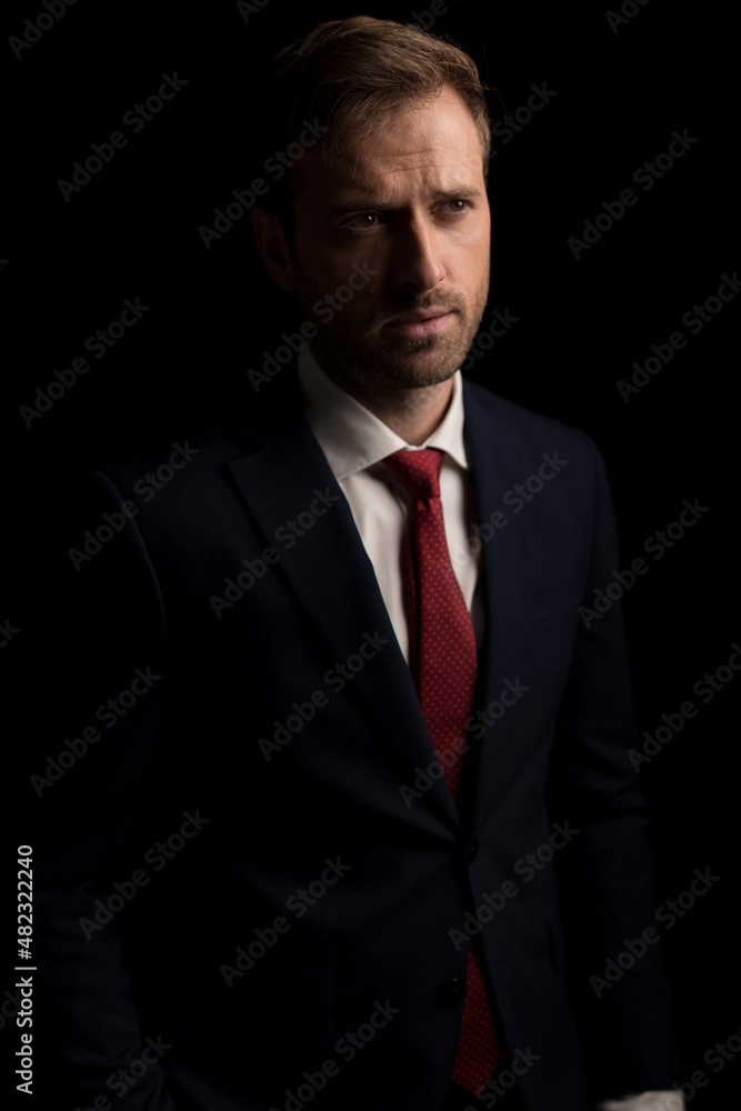 young businessman wearing a nice suit and looking away young businessman wearing a nice suit and looking away