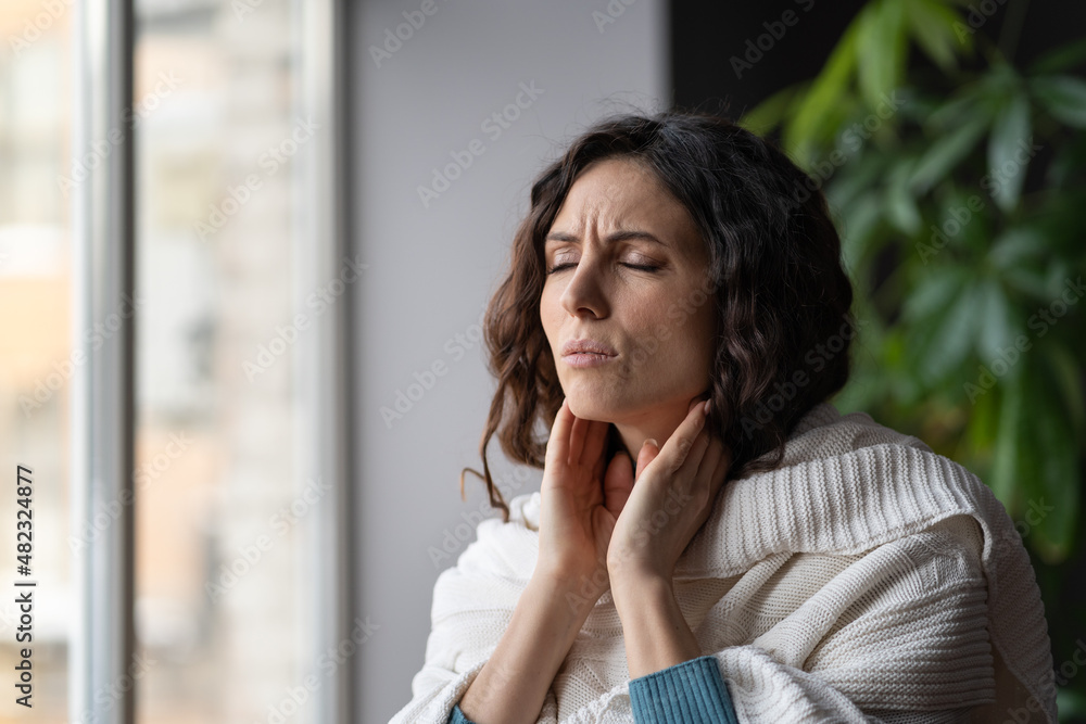 Frustrated woman touch neck check glands during cold, fever and seasonal influenza. Girl suffer from painful throat, ache, swallowing difficulties and loss of voice from angina or coronavirus illness Frustrated woman touch neck check glands during cold, fever and seasonal influenza. Girl suffer from painful throat, ache, swallowing difficulties and loss of voice from angina or coronavirus illness