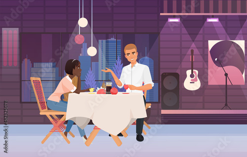 Couple having dinner on live music concert event. Lovely pair spending time on musical evening meal show