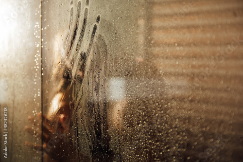 sexy couple hugging and taking shower with loofah in cabin