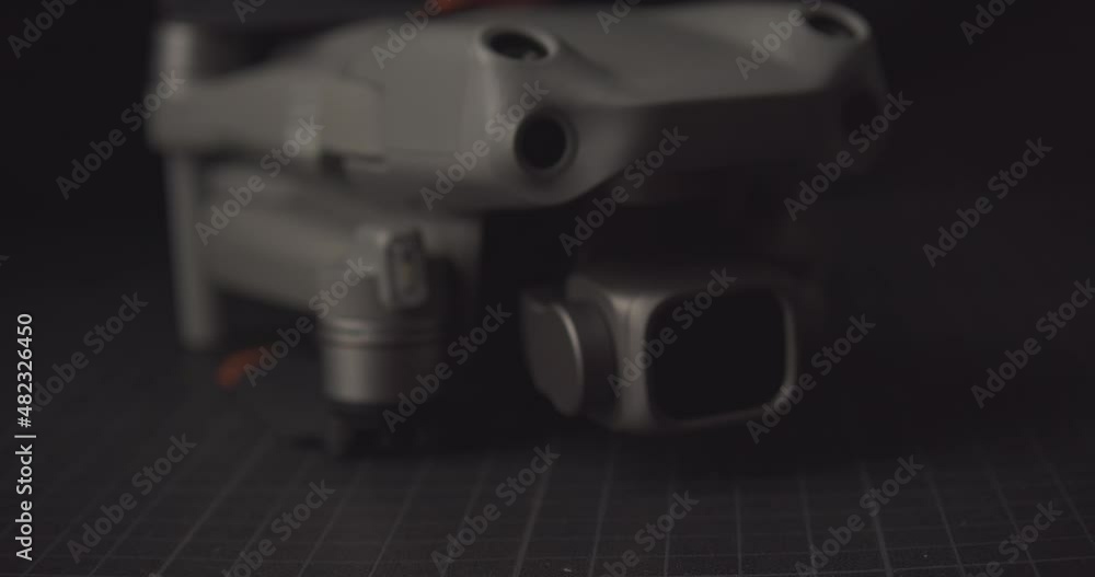 Dolly forward approaching drone on ground. Shallow focus Dolly forward approaching drone on ground. Shallow focus