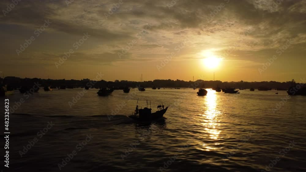 Boat goes out for fishing trip at sunrise. Aerial forward view. Vietnam Boat goes out for fishing trip at sunrise. Aerial forward view. Vietnam