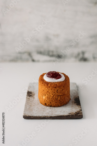 Runebergin torttu, famous Finnish Runeberg cake tart pastry made of almonds, rum, raspberry jam, pink background. Baked on February 5, Runeberg's birthday photo