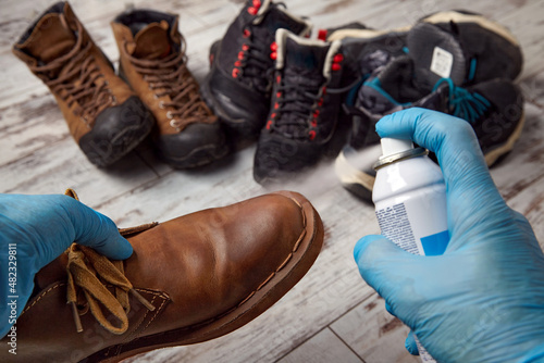 Processing of shoes with impregnation of water protection. Cleans the shoes in the autumn winter period photo