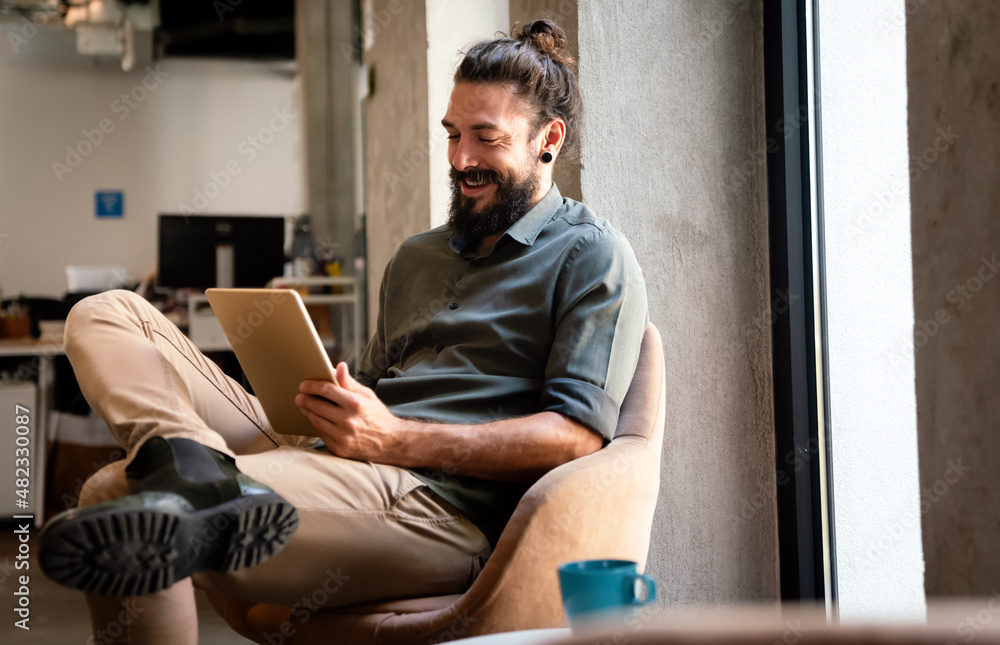 Portrait of successful handsome business man using digital tablet in office Portrait of successful handsome business man using digital tablet in office