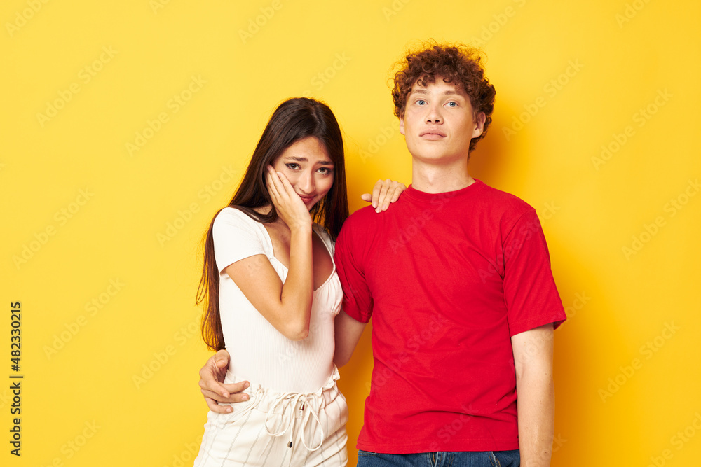 Fototapeta premium cute young couple hug together antics isolated background unaltered