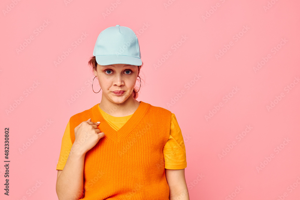 beautiful woman grimace earrings cap fashion pink background unaltered