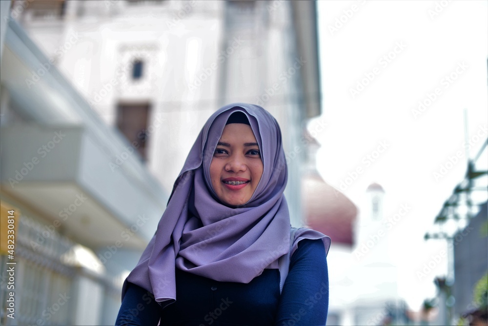 Modern muslim woman wearing headscarf walking in the street Modern muslim woman wearing headscarf walking in the street