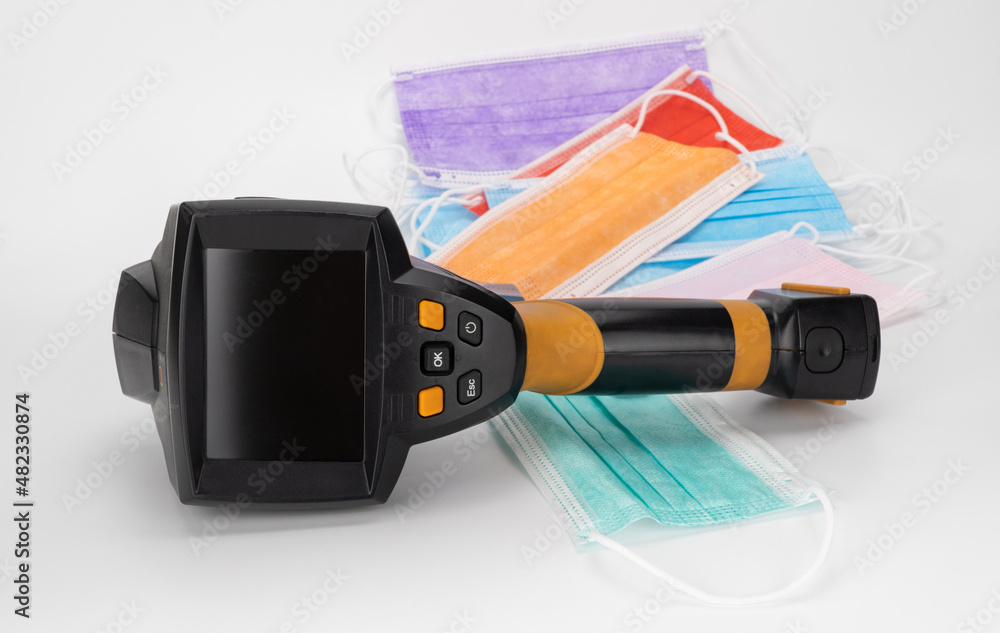 thermal imager and medical masks on a white background. temperature