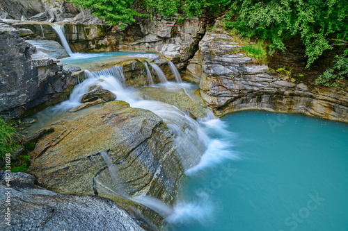 Idyllic shot of water flowing on mountain stream in blue lake, Vanoise National Park, France photo