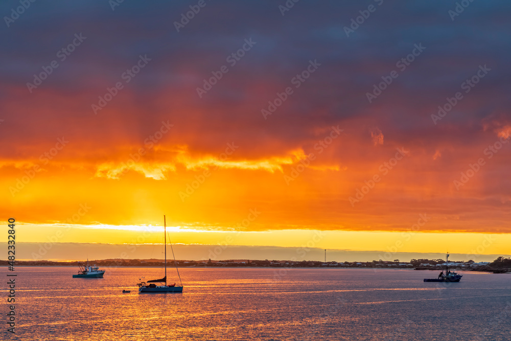 Australia,South Australia, Robe, Cloudy sky over boats floating near coast at moody sunset Australia,South Australia, Robe, Cloudy sky over boats floating near coast at moody sunset