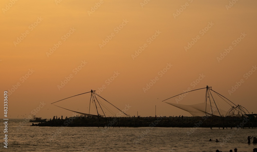 sunset at the beach, Chinese nets to catch fish